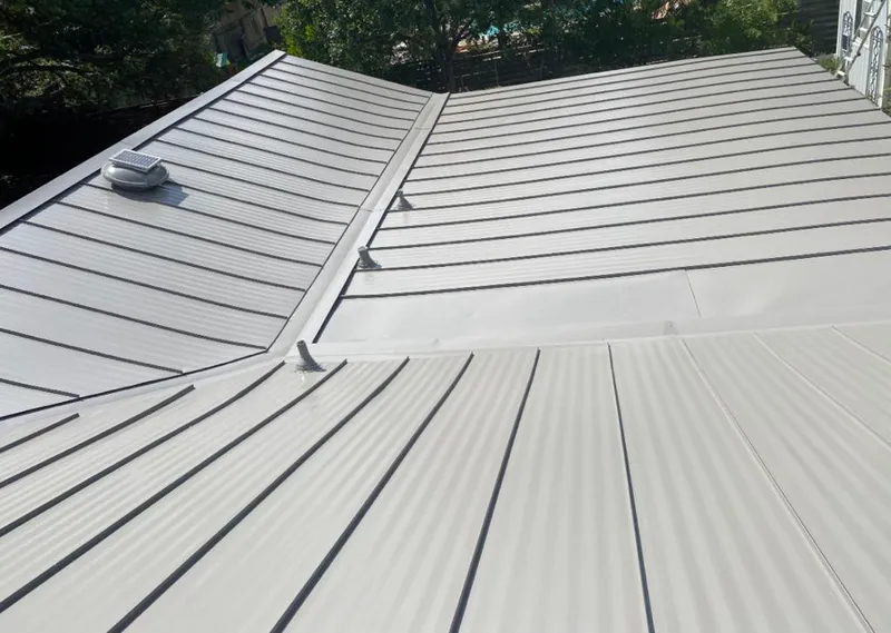 Solar attic fan installed on a metal roof for Roof Ventilation in Secaucus