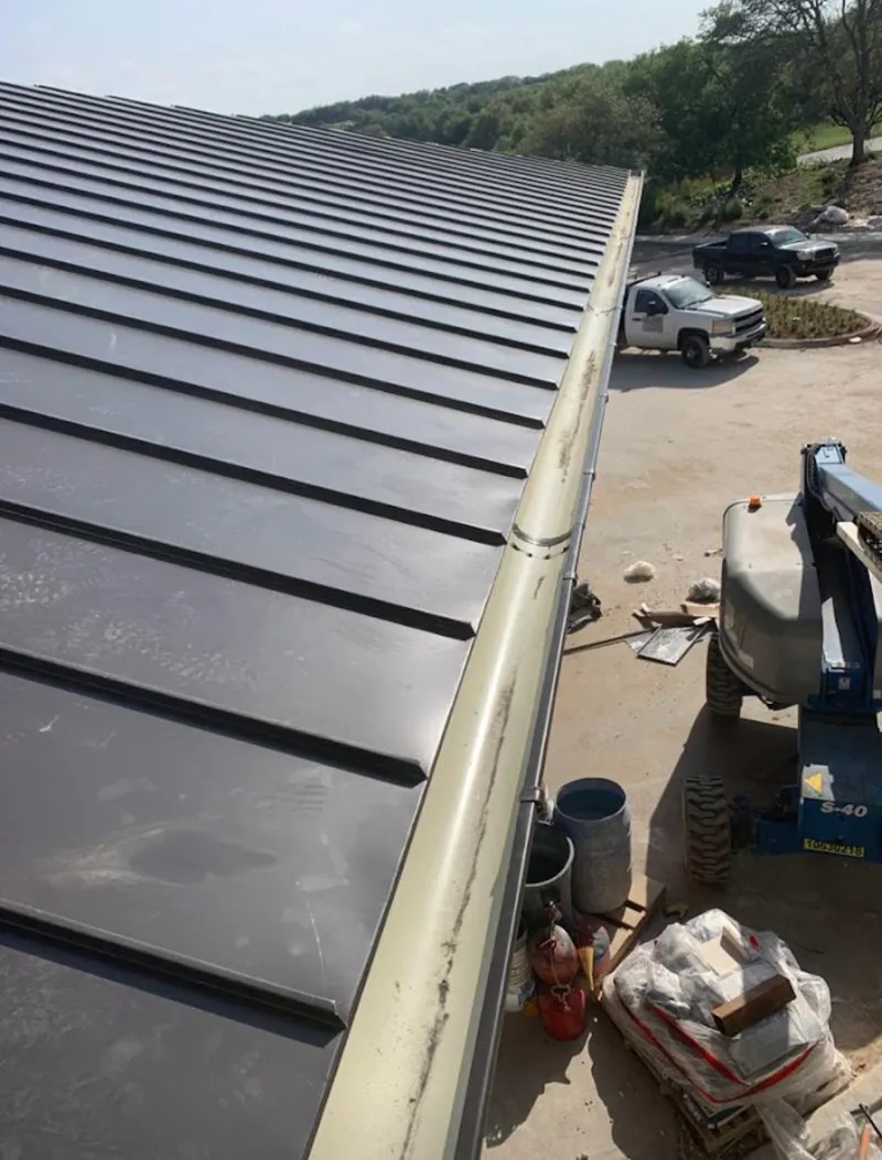 Standing seam panel and gutter detail on a metal roofing jobsite in Secaucus